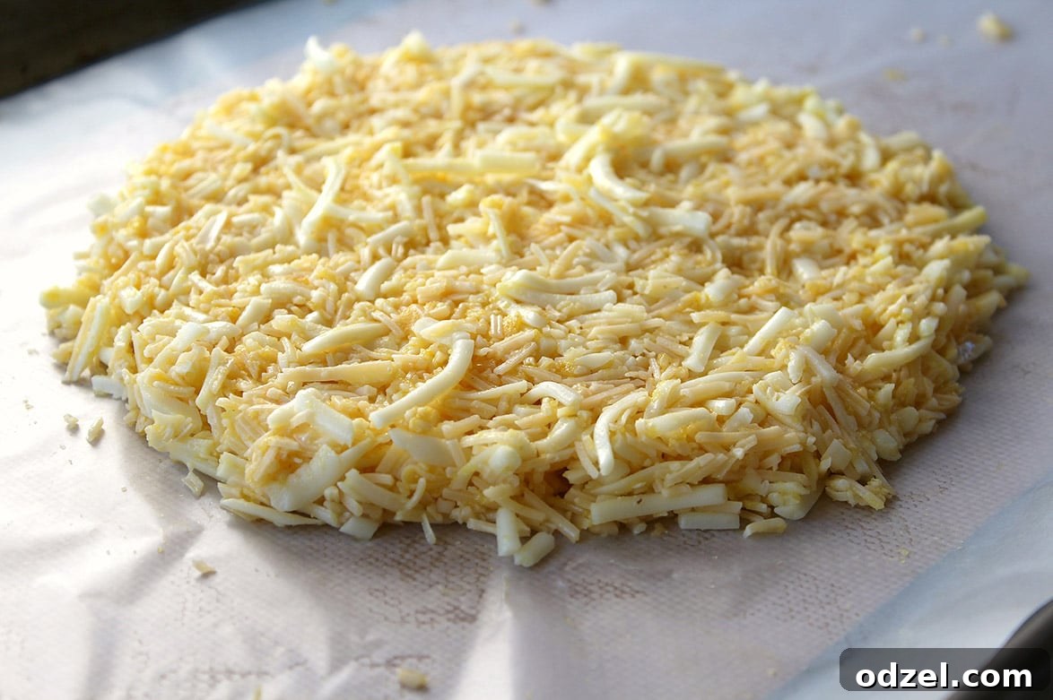 Golden Keto Cheese Bread 4 Raw keto cheese bread mixture flattened on a baking sheet with parchment paper