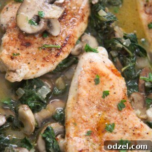 Chicken, spinach, and mushrooms in a skillet, ready to serve.