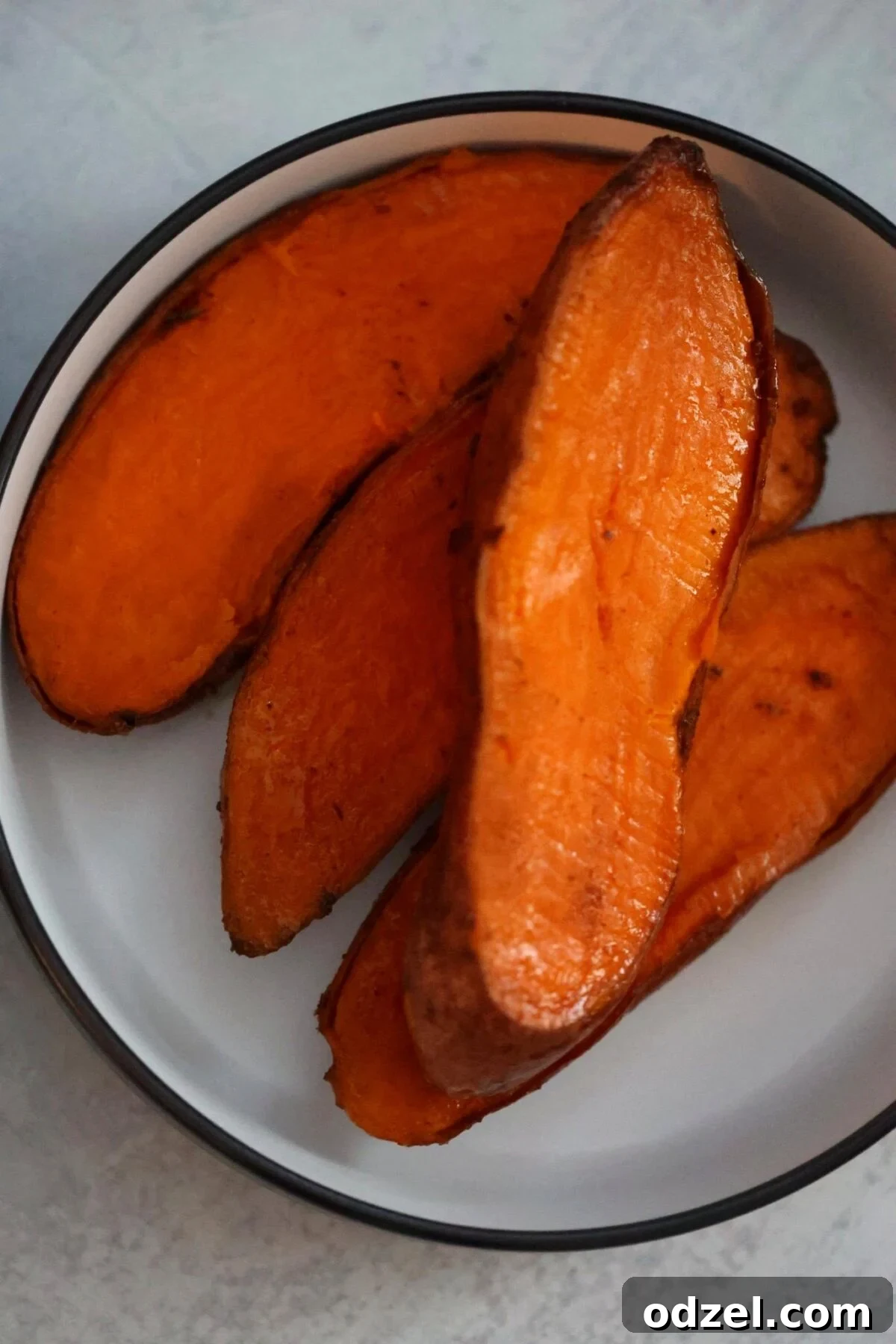 Close-up of perfectly cooked and caramelized sweet potatoes, showing their tender texture and golden-brown edges.