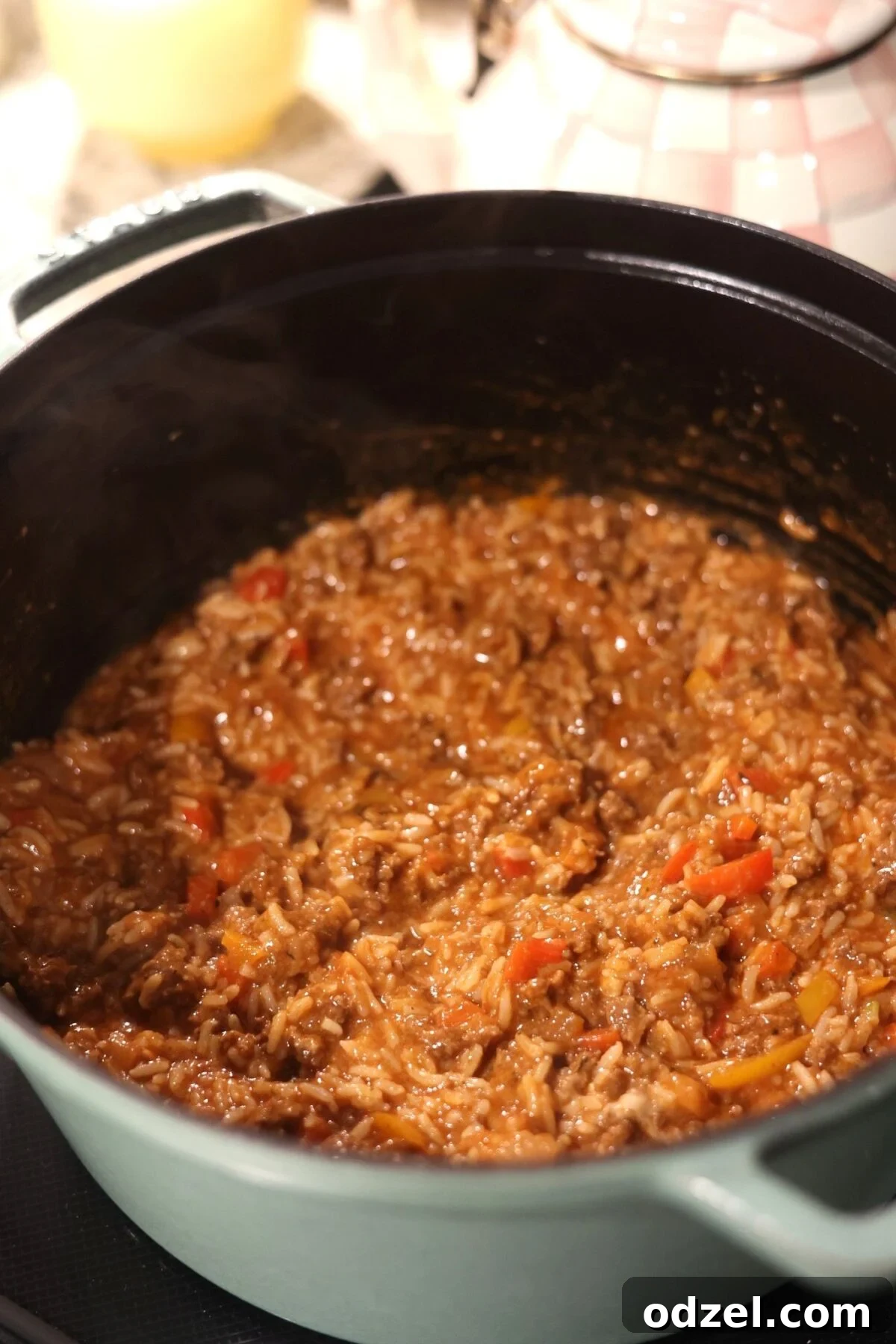Savory Stuffed Bell Peppers 3 Sautéing ground beef and rice in a black Dutch oven, illustrating the flavorful filling preparation.