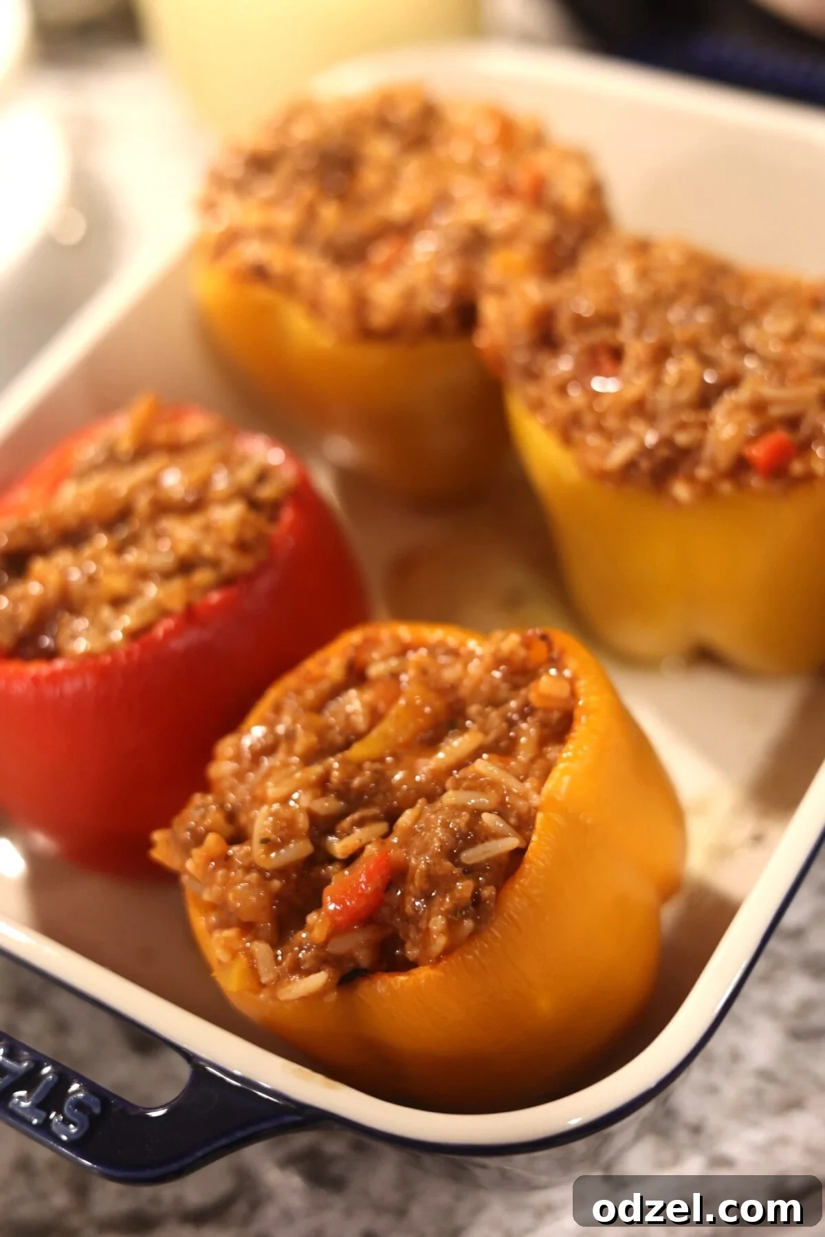 Savory Stuffed Bell Peppers 4 Four stuffed peppers ready for cheese, showcasing the beef and rice filling before the final bake.