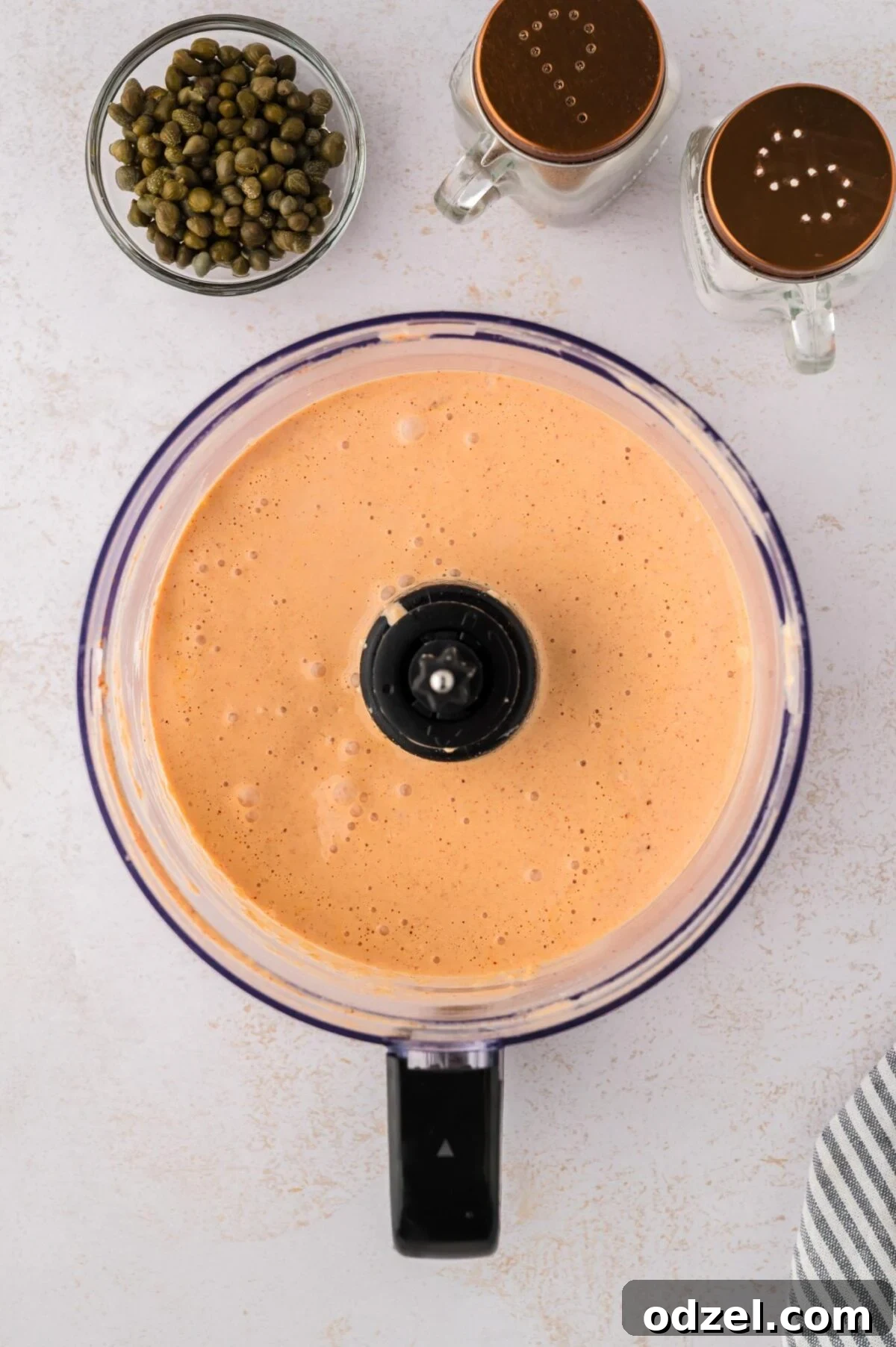 remoulade sauce in a food processor with capers and salt and pepper on the side. 