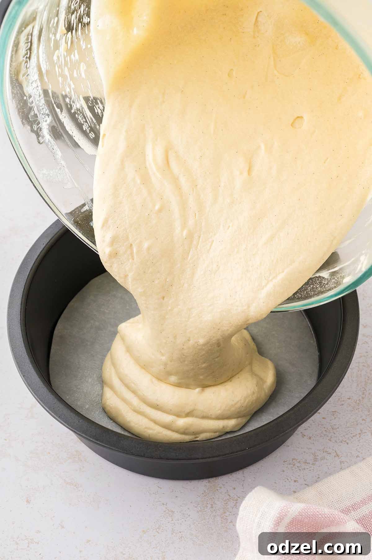 Light and Creamy Chantilly Cake Recipe for Special Occasions 5 Cake batter being poured into a 9 inch cake pan.