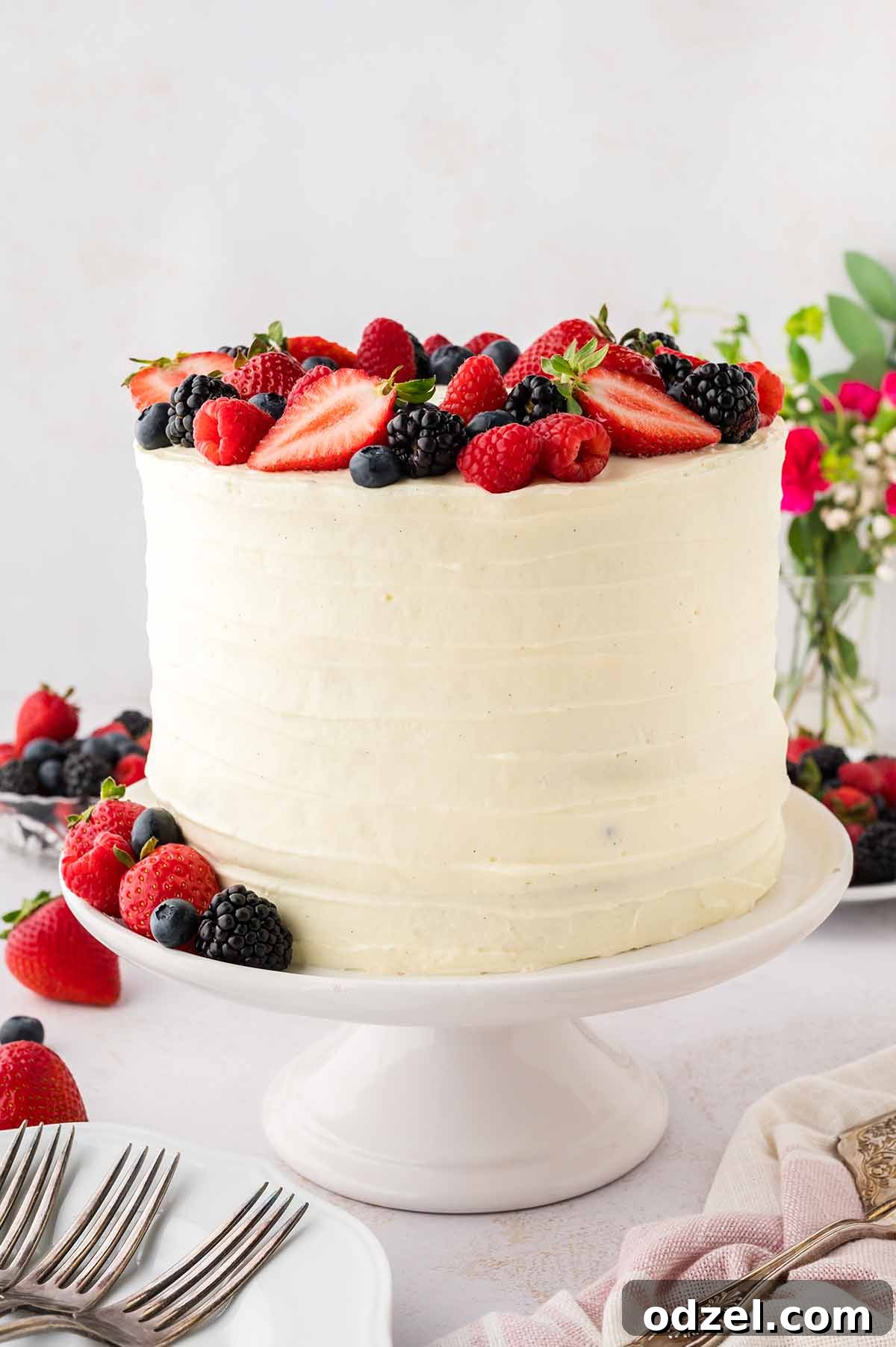 Light and Creamy Chantilly Cake Recipe for Special Occasions 10 Frosted cake with berries on top.