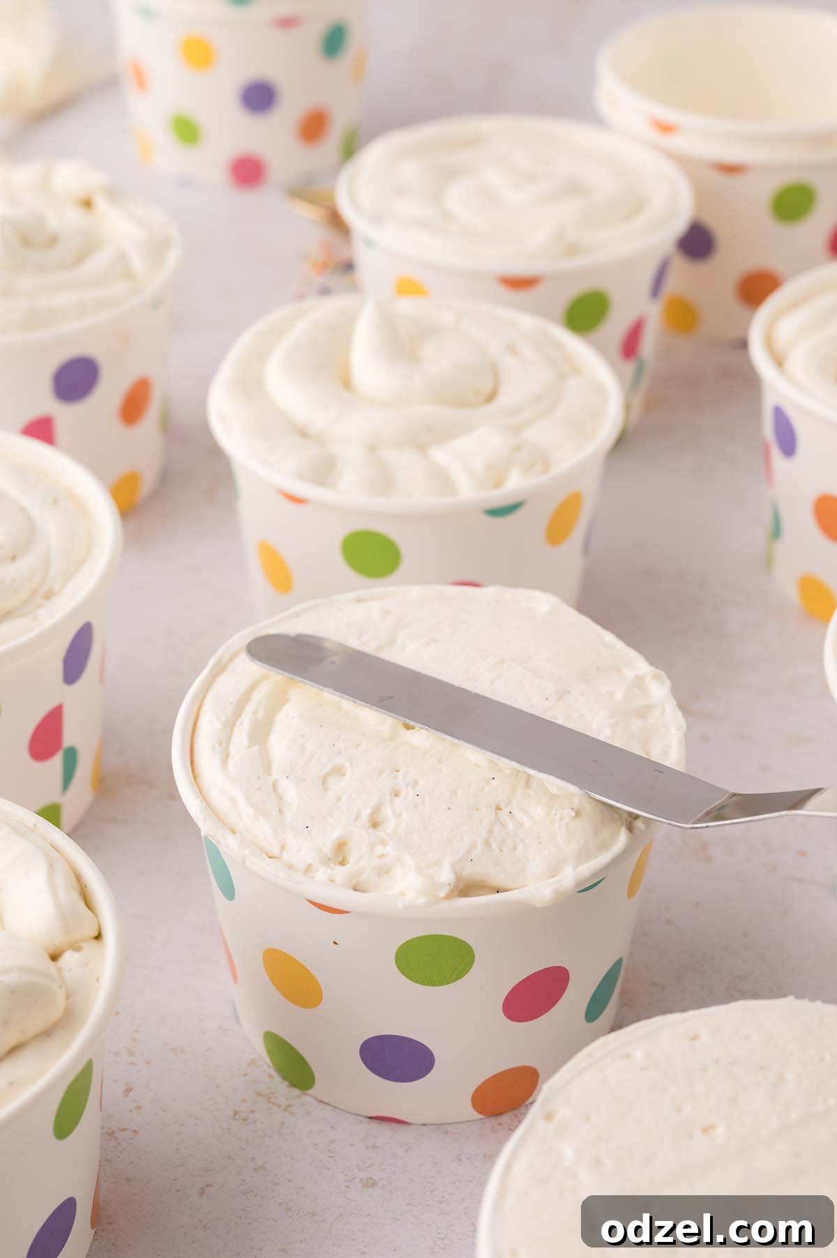 Copycat Dot Cakes Recipe: Make Classic Mini Cake Bites at Home 9 Offset spatula smoothing the buttercream frosting.