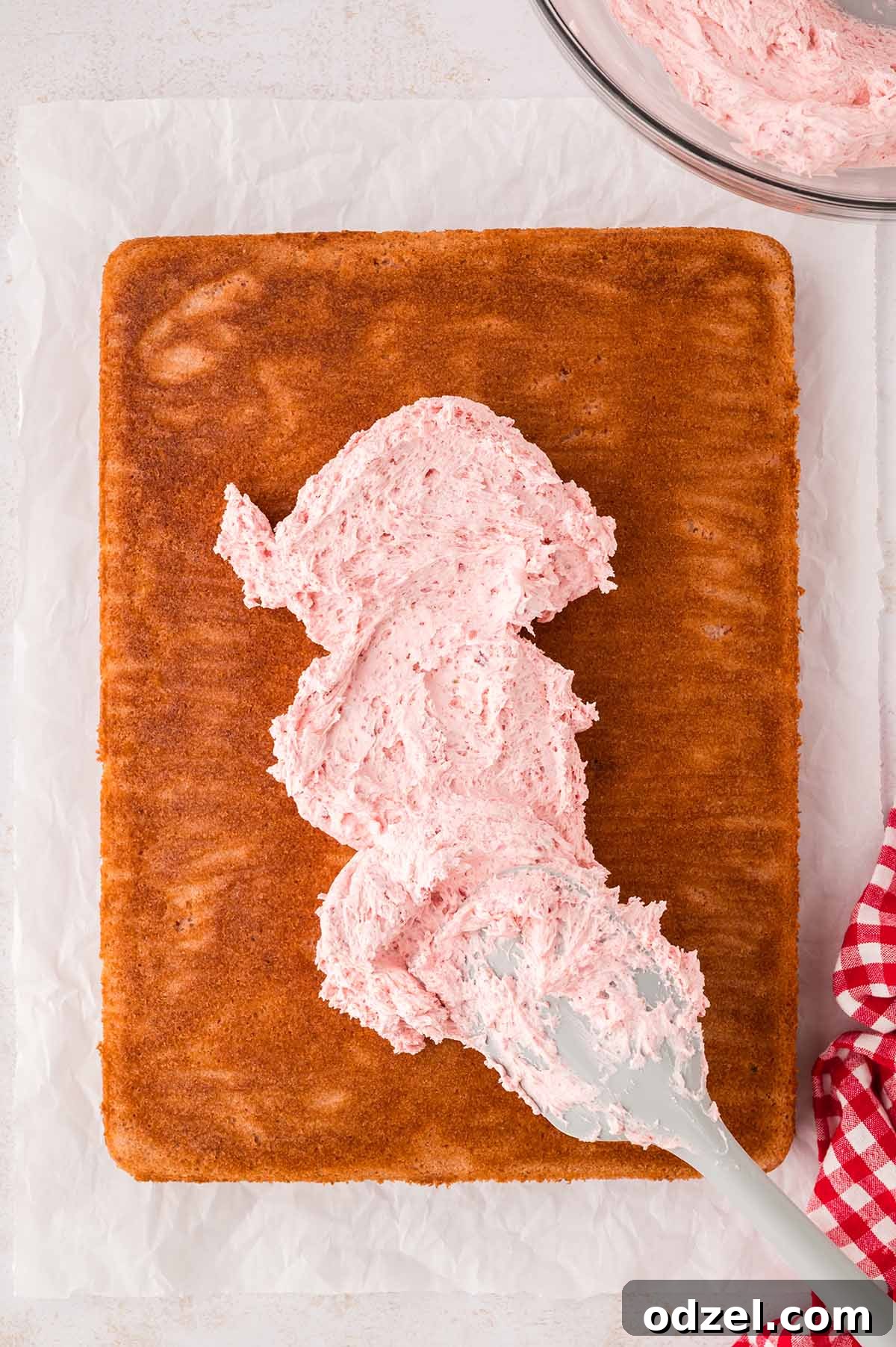 Moist Fresh Strawberry Sheet Cake Recipe 7 Cake being frosted with buttercream.