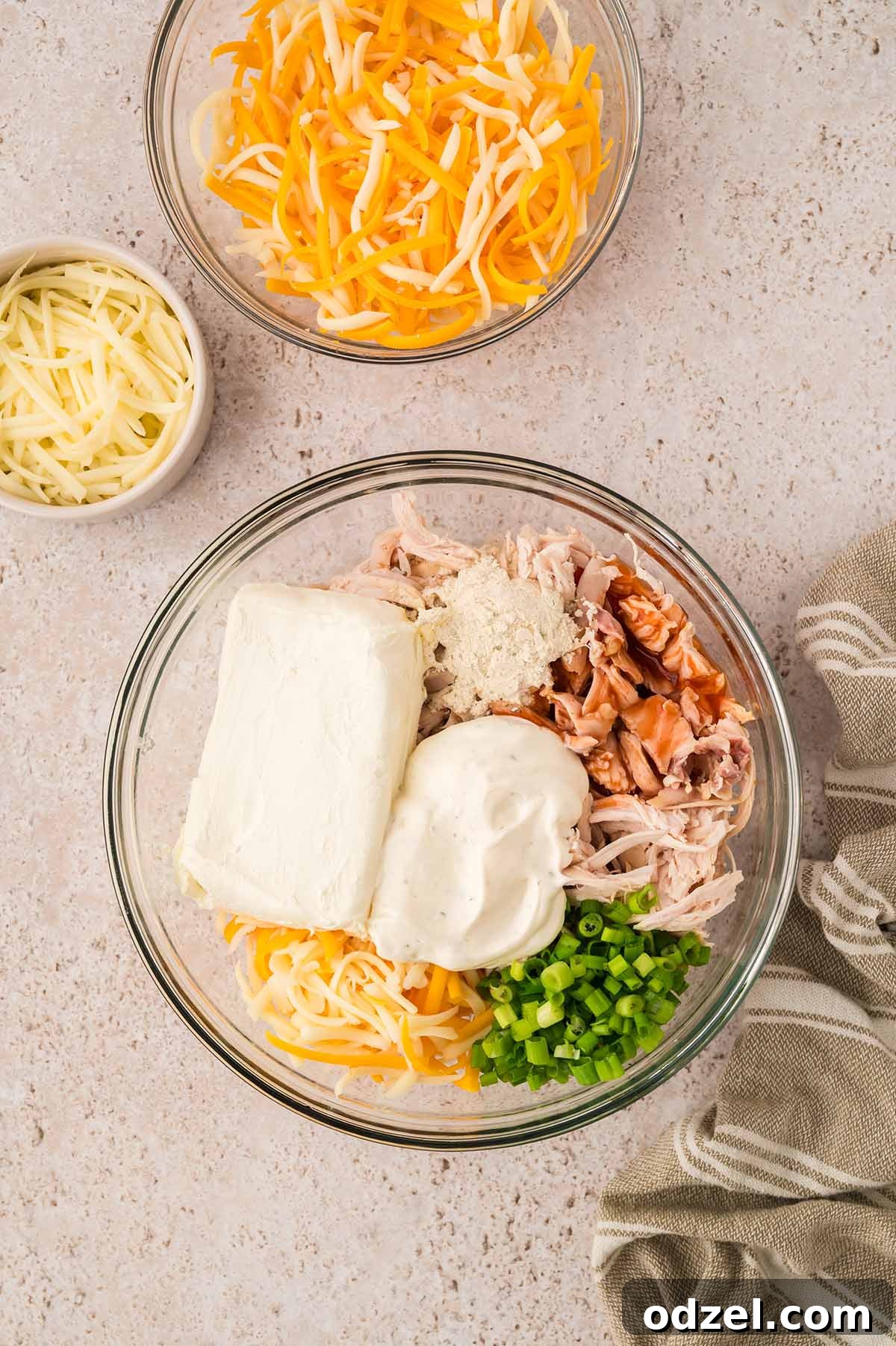 Classic Buffalo Chicken Dip Recipe 4 buffalo chicken dip ingredients in a glass bowl.