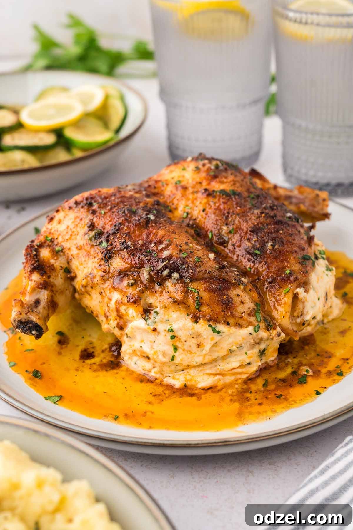 Copycat Ruth's Chris Stuffed Chicken Recipe 5 Stuffed chicken on a white plate.