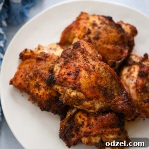 roasted chicken thighs on a white plate.