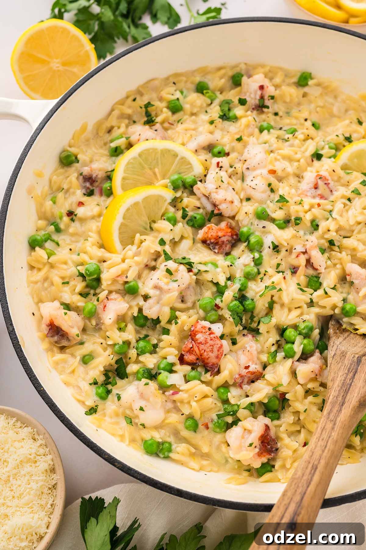 Creamy Lemon Garlic Lobster Orzo Recipe 2 lemon garlic lobster orzo in a white skillet.