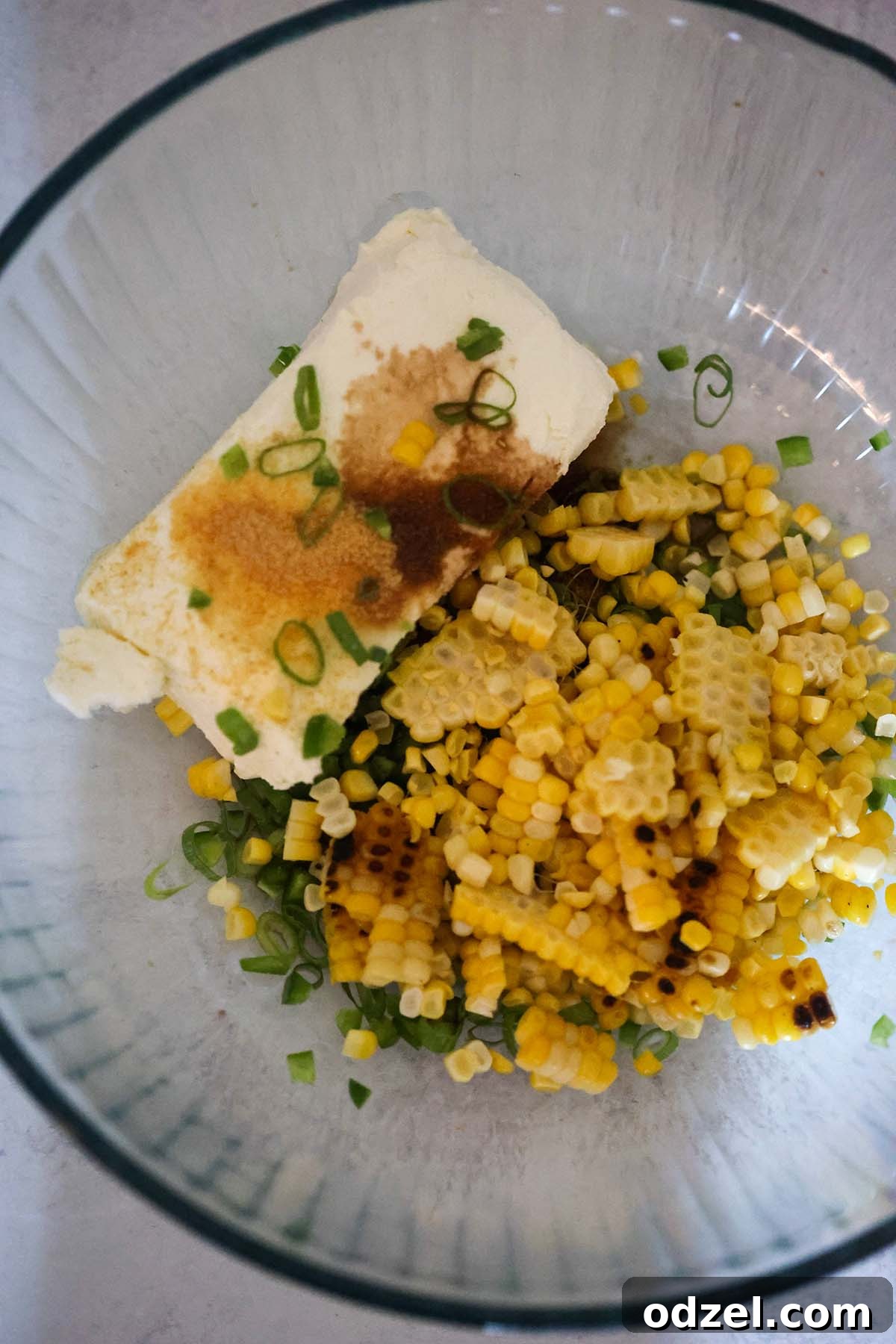 Crispy Sweet Corn and Cheese Rangoons 5 cream cheese, scallions, and corn in a bowl.