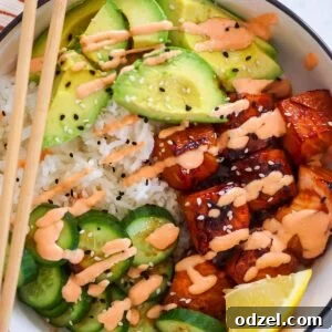salmon avocado rice bowl with chop sticks.